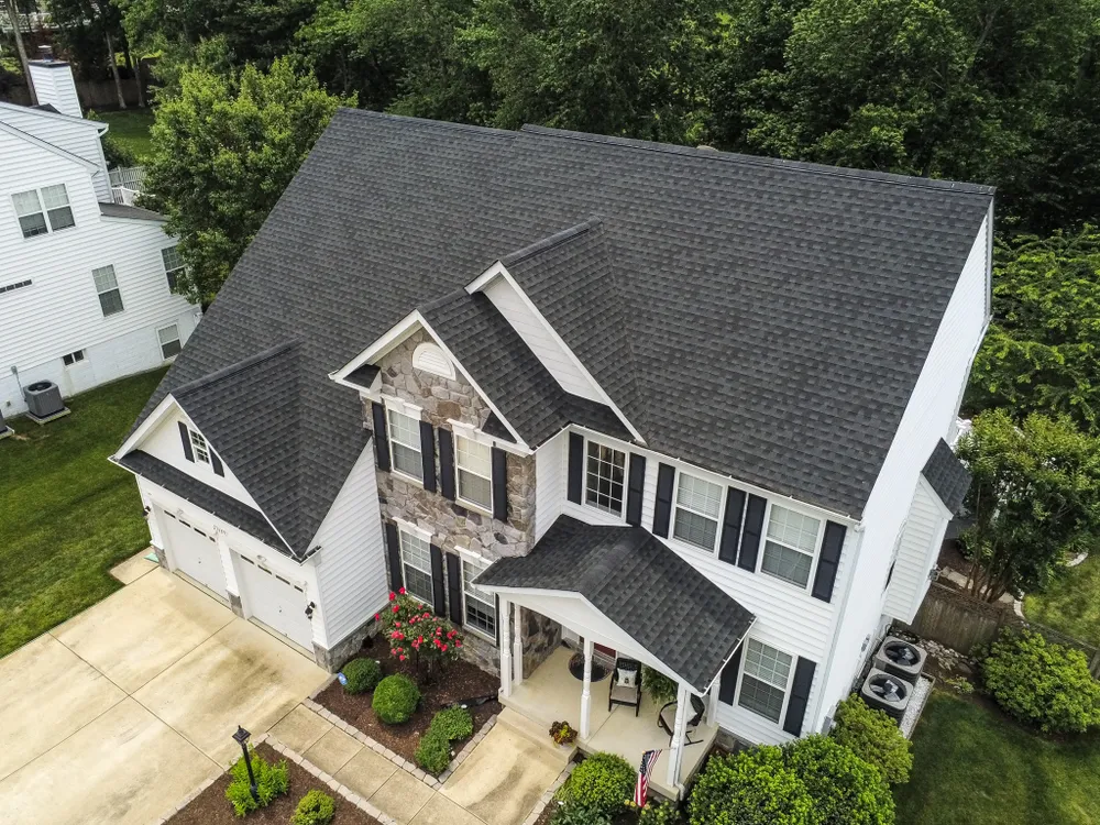 Two-story Waldorf, MD colonial with stone front accent and a brand new black architectural asphalt shingle roof