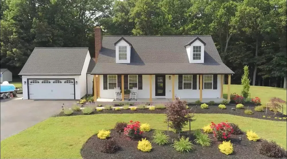 Charlotte Hall, MD Cape Cod with twin dormers, attached garage and a new brown architectural shingle roof installed by Summit Exteriors