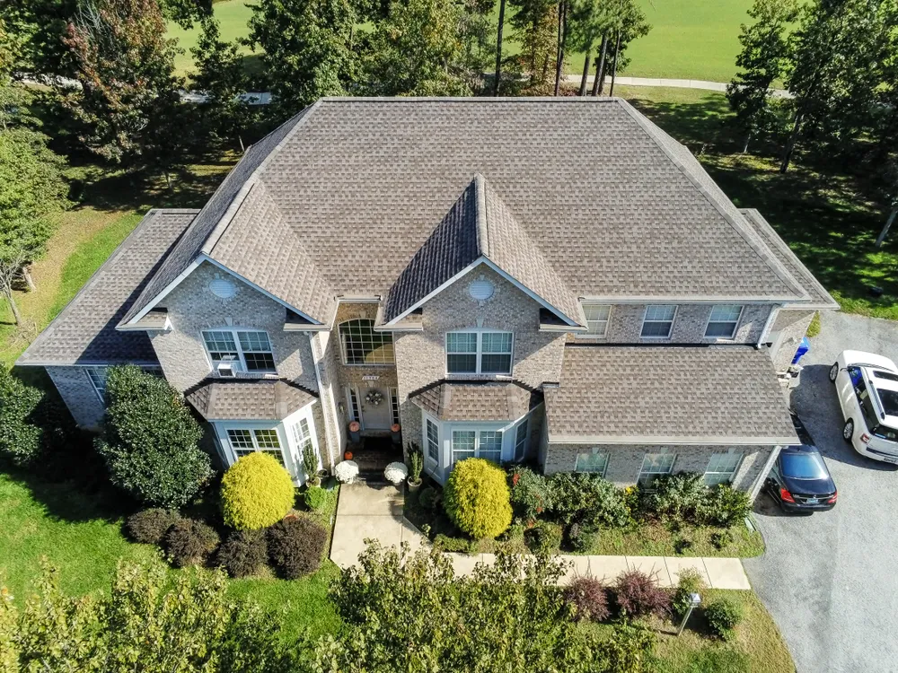 Large two-story brick colonial in Prince Frederick, MD with a new architectural asphalt shingle roof installed by Summit Exteriors