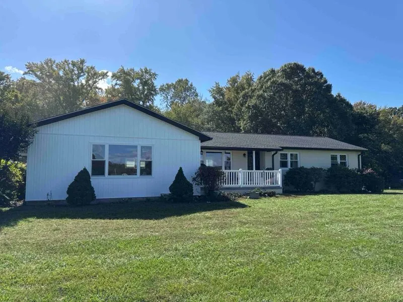 Completed roof replacement on a single-story ranch home with white siding in California, MD