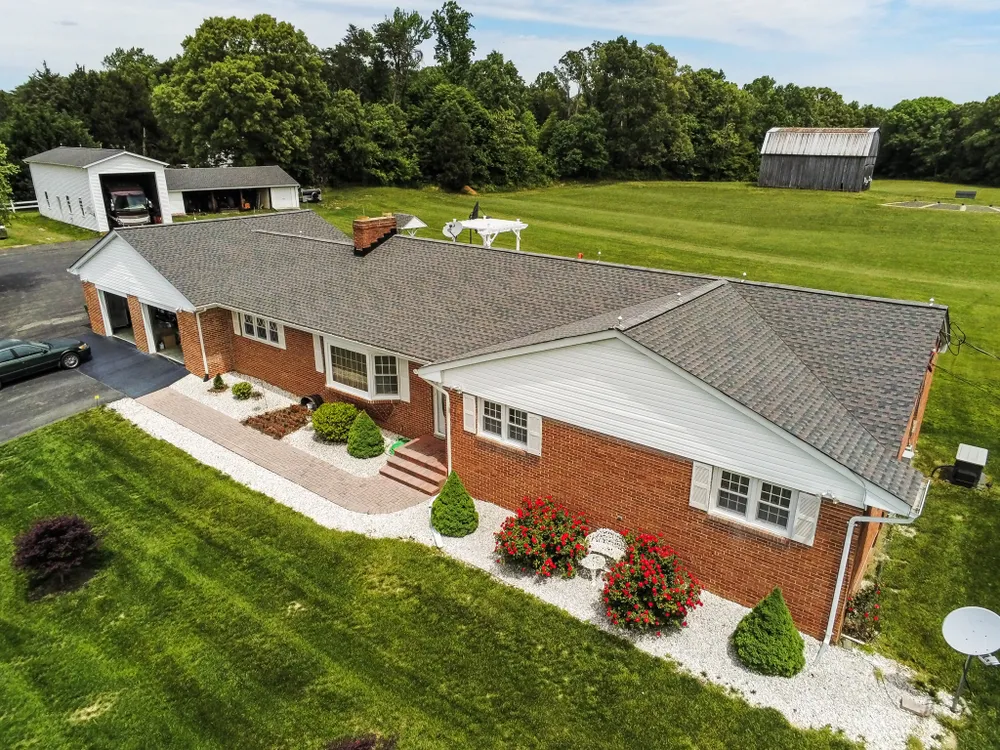 Sprawling brick rancher in Mechanicsville, MD with a freshly installed architectural shingle roof and seamless gutters