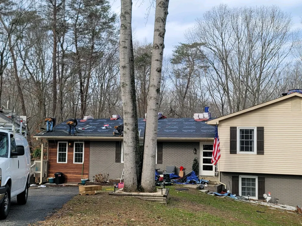 Summit Exteriors crew installing a new architectural shingle roof on a brick rancher in Huntingtown, MD on a winter morning